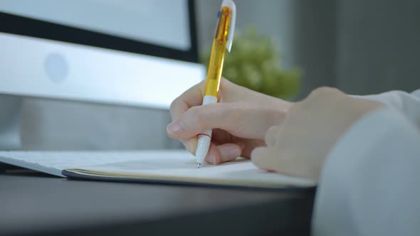 Secretary Writing Notes In Book