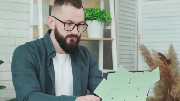 Man is Tired From Working on the Computer Takes Off Glasses to Rest His Eyes