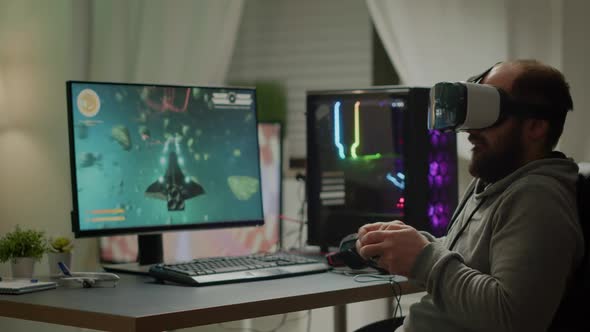 Videogame Player with VR Headset Raising Hands After Winning Space Shooter