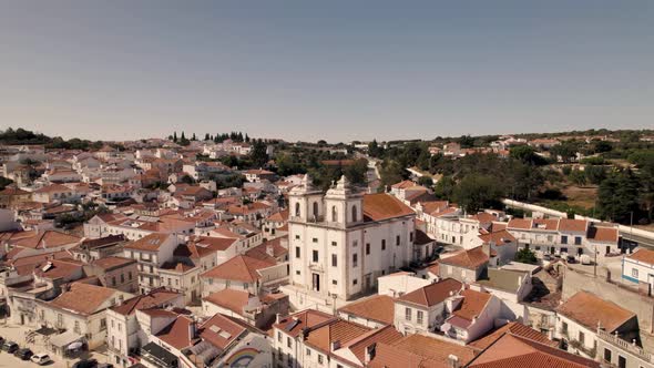 Historical church with two towers and majestic cityscape of Alcacer Do Sal town in Portugal