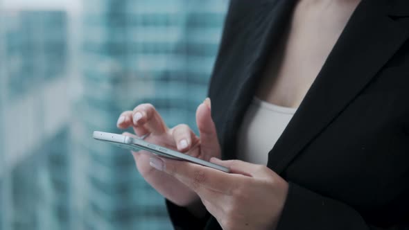 Smartphone in the Hands of a Woman. Girl Uses a Mobile Phone