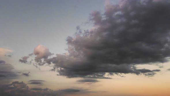 Wideangle Panorama of a Dark Evening Sky with Blue Clouds in Sunlight