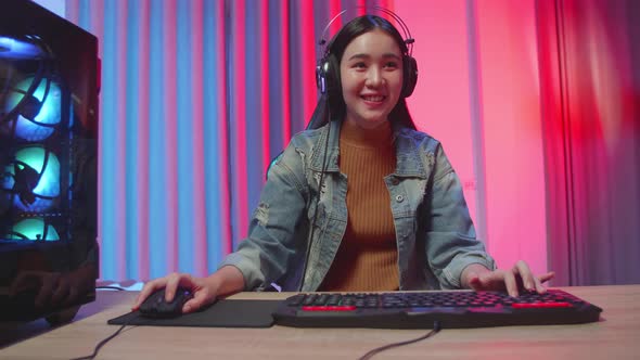 Excited Asian Girl Gamer Playing Video Game On Computer