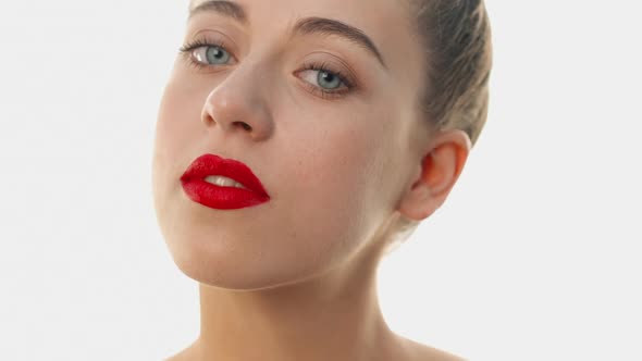 Girl Turns Her Head Full Face, Looking at the Camera. The Woman Has Expressive Blue Eyes, Clean Skin