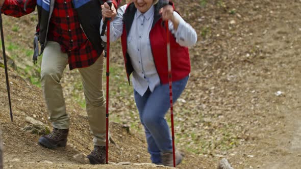 Cheerful Pensioners Trekking Up Hill