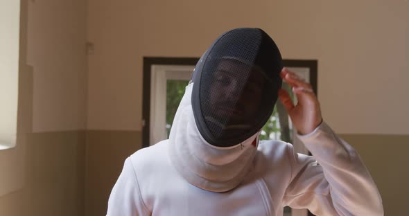 Fencer athlete during a fencing training in a gym