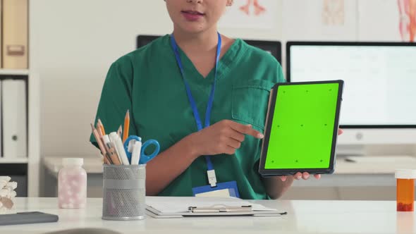 Doctor Using Tablet with Green Screen and Talking to Patient