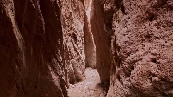 Drone Flying Through Narrow Canyon in Mountains