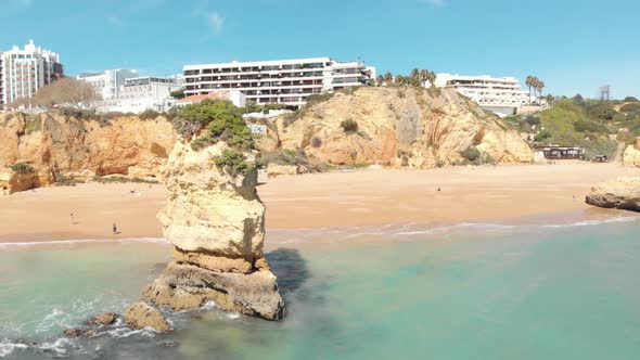 Idyllic Dona Ana beach encircled by Lagos cliffs and turquoise Algarve sea, Portugal