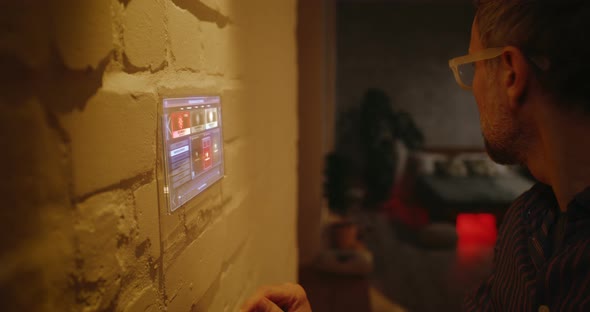 Man Controlling Lighting with Home Hub