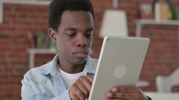 Ambitious African Man Using Tablet