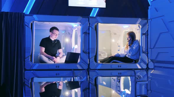 Young People are Happily Spending Time in a Capsule Hotel