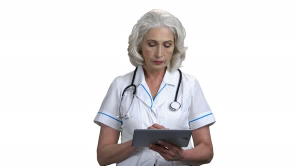 Confident Female Doctor Working on Digital Tablet alt