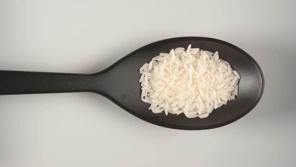 Black Spoon Is Filling By A White Rice