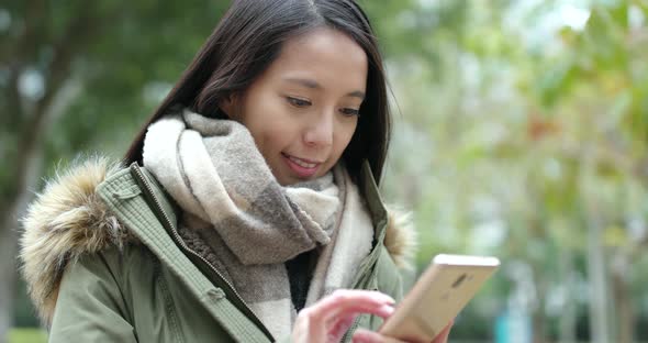 Woman use of mobile phone at park