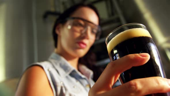 Close-up of female brewer testing beer