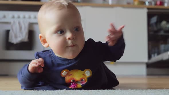 Baby Girl Making Efforts To Crawl on the Floor at Home