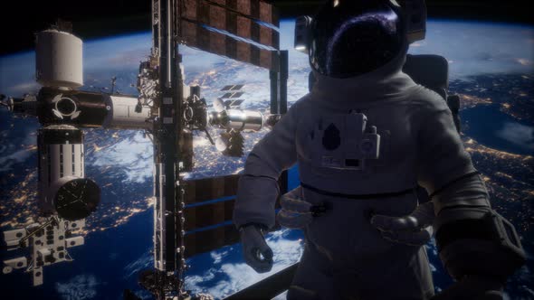 International Space Station and Astronaut in Outer Space Over the Planet Earth