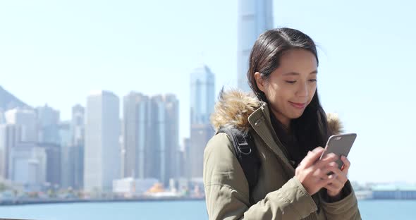 Woman using smart phone in Hong Kong