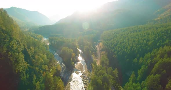 Low Altitude Flight Over Fresh Fast Mountain River with Rocks at Sunny Summer Morning.