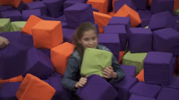 Children Playing with Soft Cubes in Game Center