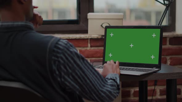 Company Worker Using Laptop with Green Screen in Business Office