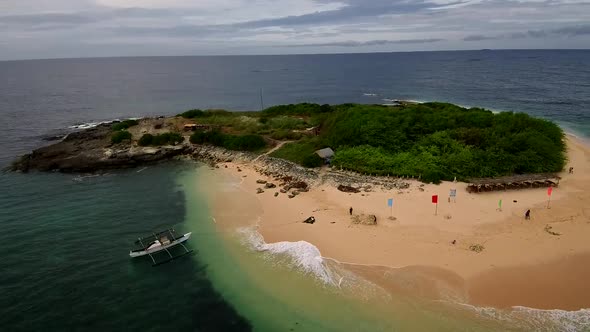 Aerial drone video of an exotic white sand tropical island in the Southeast Asia