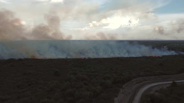 Aerial view of a wildfire burning short vegetation, Cambodia.