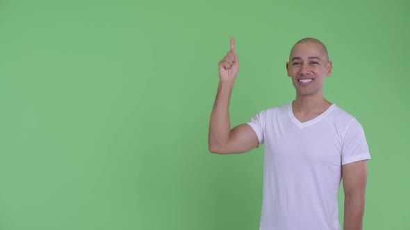 Happy Handsome Bald Man Thinking and Pointing Up