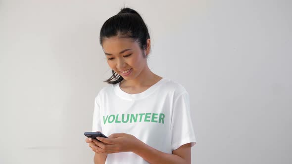 Asian Volunteer with Smartphone