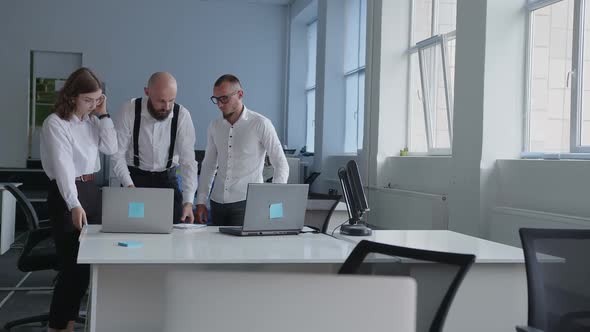 Colleagues Write Some Important Issues and Watch on the Laptop's Screen