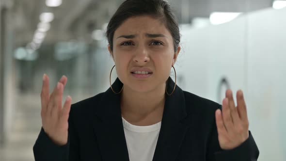 Portrait of Young Indian Businesswoman Reacting to Loss Failure