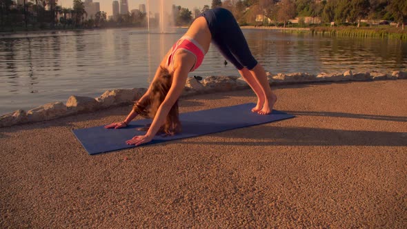 Woman Doing Yoga In The Park At Dawn