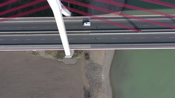 Vehicles Crossing a Cable Stayed Suspension Bridge Crossing a River