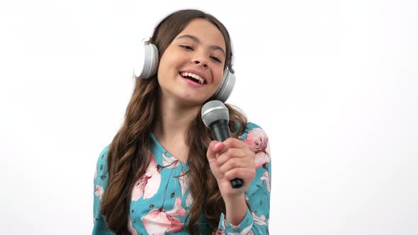 Happy Child in Headphones Talk to Camera Interviewing and Giving Microphone to Respondent Interview