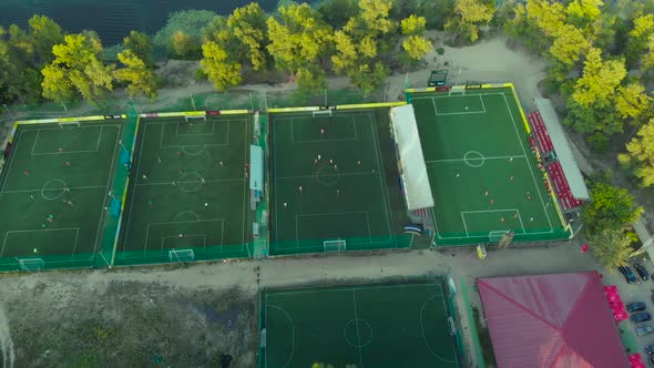 Park with Many Football Fields Near the River.