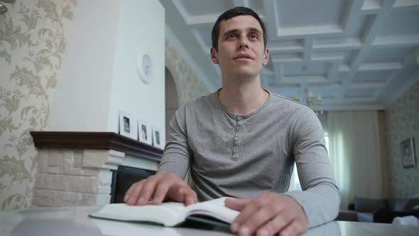 Blind Man Reading a Braille Book