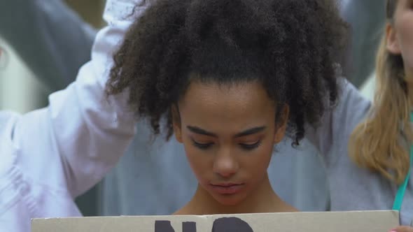 Upset Girl Holding Banner With No Harassment Slogan, Against Domestic Violence