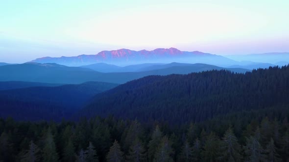 Early morning mountain forest sunrise. Aerial View Mountain Layers. Blue hour light