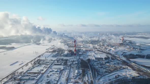 Smoke from the pipes of a chemical enterprise top view. Panorama of the factory in winter.