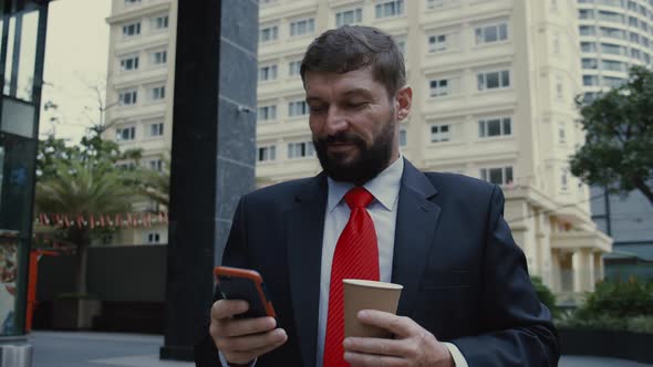 Businessman with Phone Drinking Coffee