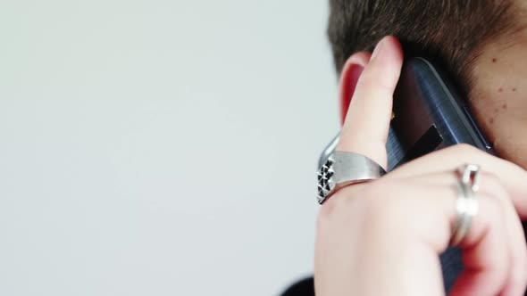 Androgynous man talking on mobile phone