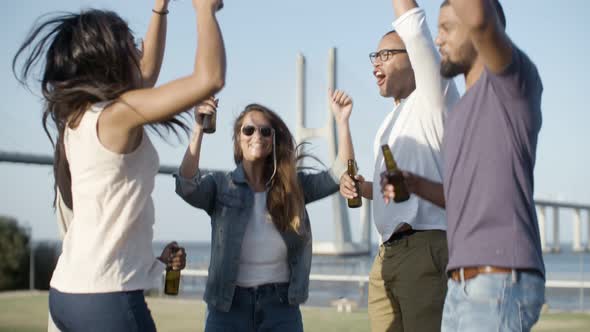 Laughing Company Jumping with Beer Bottle.