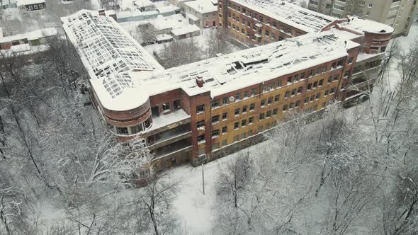 Snowcovered Highrise Residential Building with a Destroyed Roof