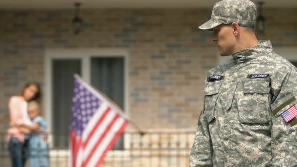 Sad Serviceman Leaving House Looking Wife and Daughter Hugging Background, Duty