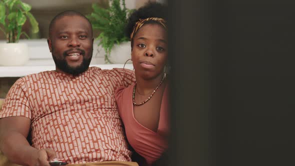 Afro Couple Watching TV At Home / Videohive