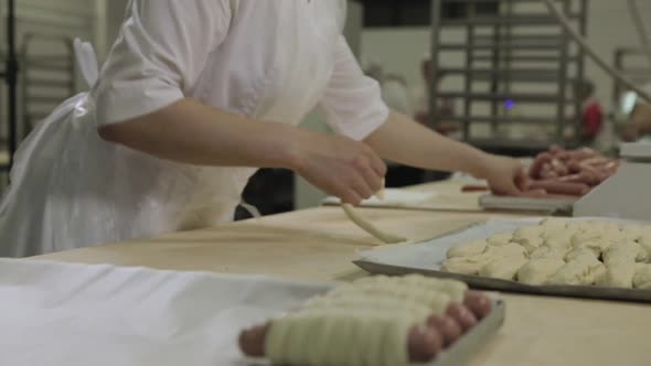 Close Up For A Woman Wrapping Sausages