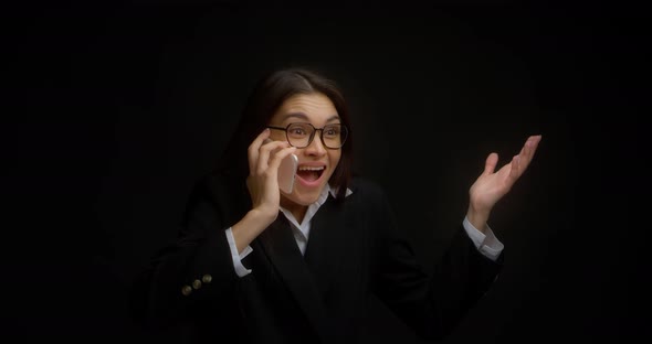 Business Woman is Glad to Hear Pleasant News in a Telephone Conversation