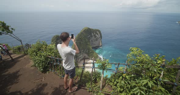 Back View of a Male Tourist Taking Pictures of the Beautiful Tropical TRex Bay Peninsula at