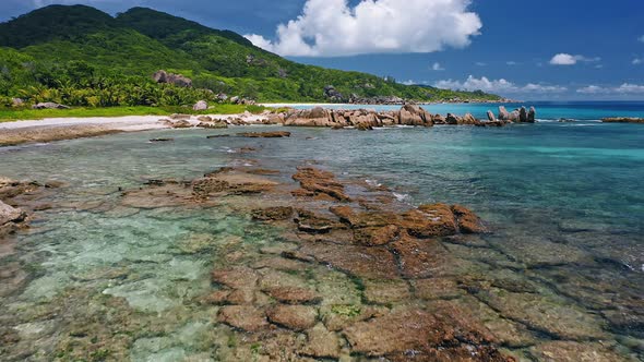 Aerial Drone Fly Above Shallow Tropical Coast with Rocks in Low Tide on Remote Beach